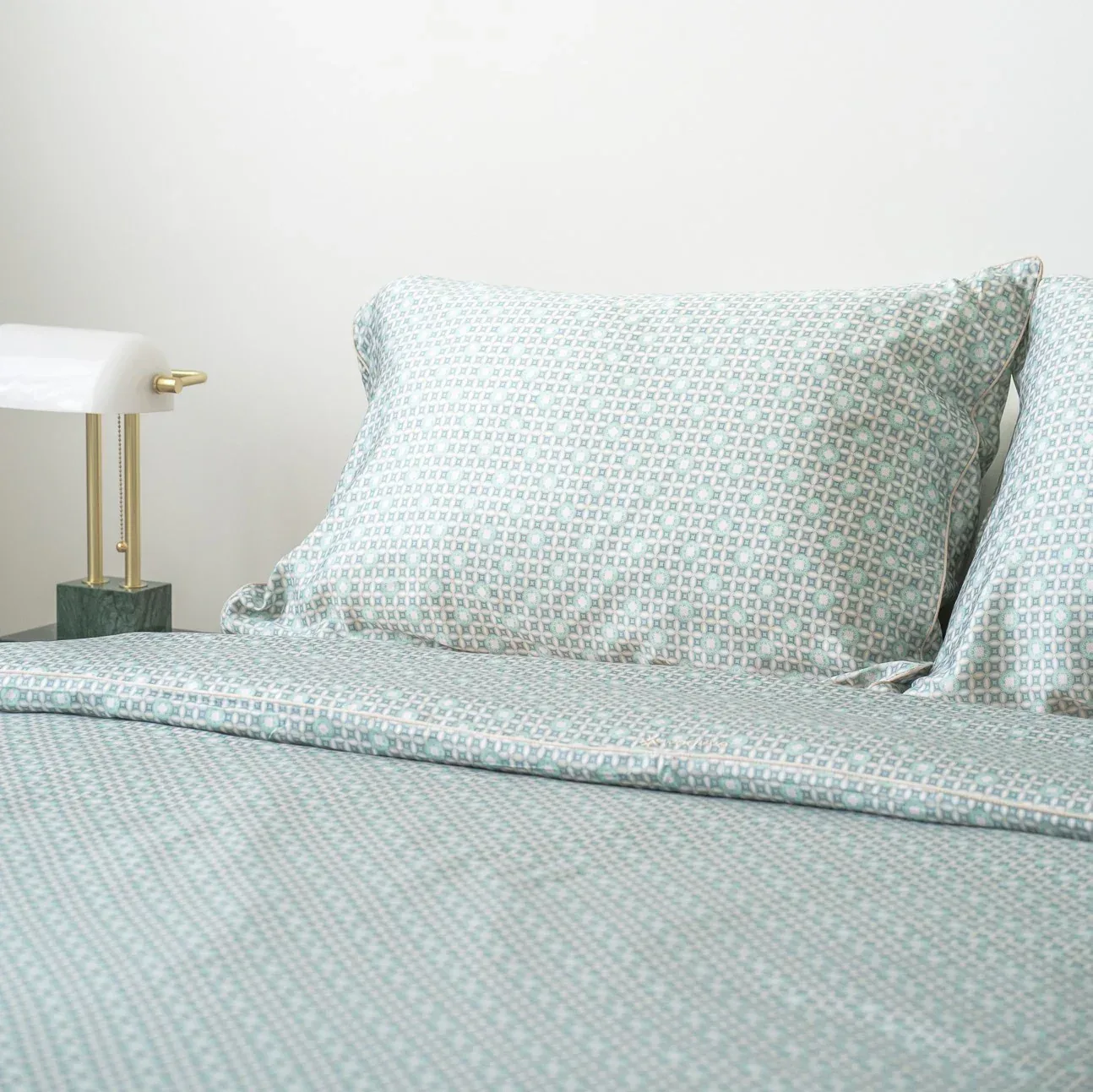 Mint patterned bedding with banker lamp