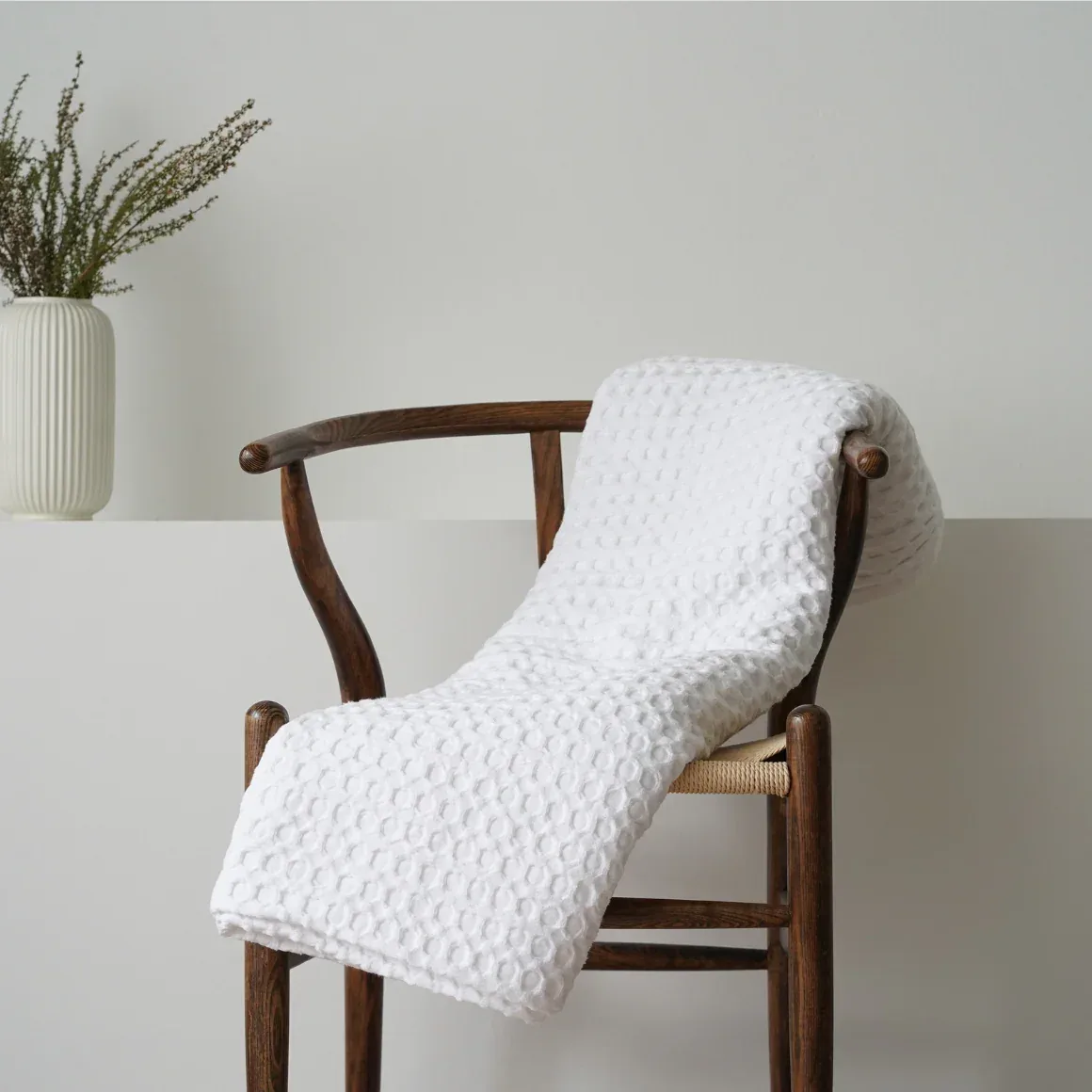 Waffle throw on a wishbone chair