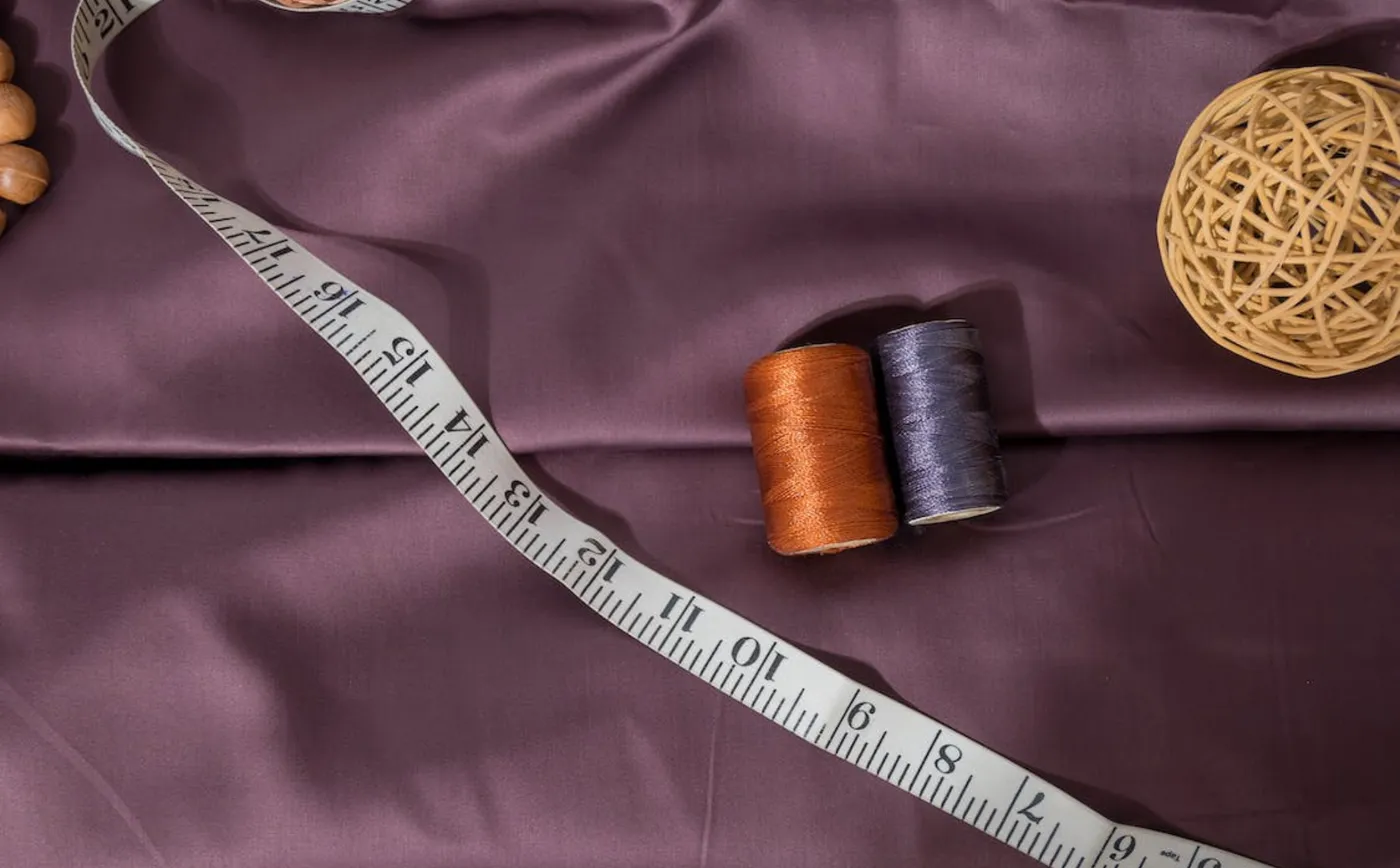 Measuring tape and thread spools on fabric